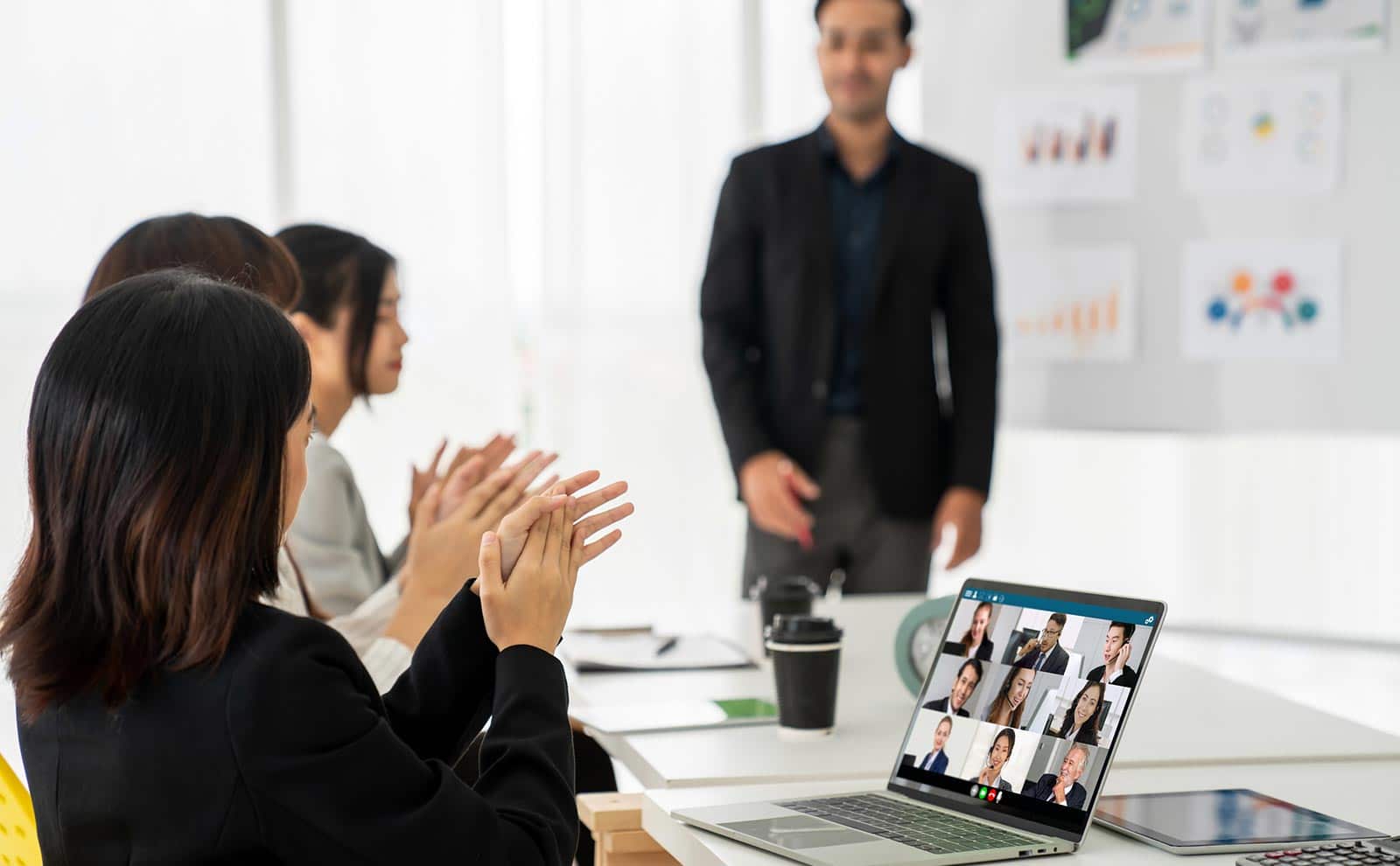 business people clapping in a meeting
