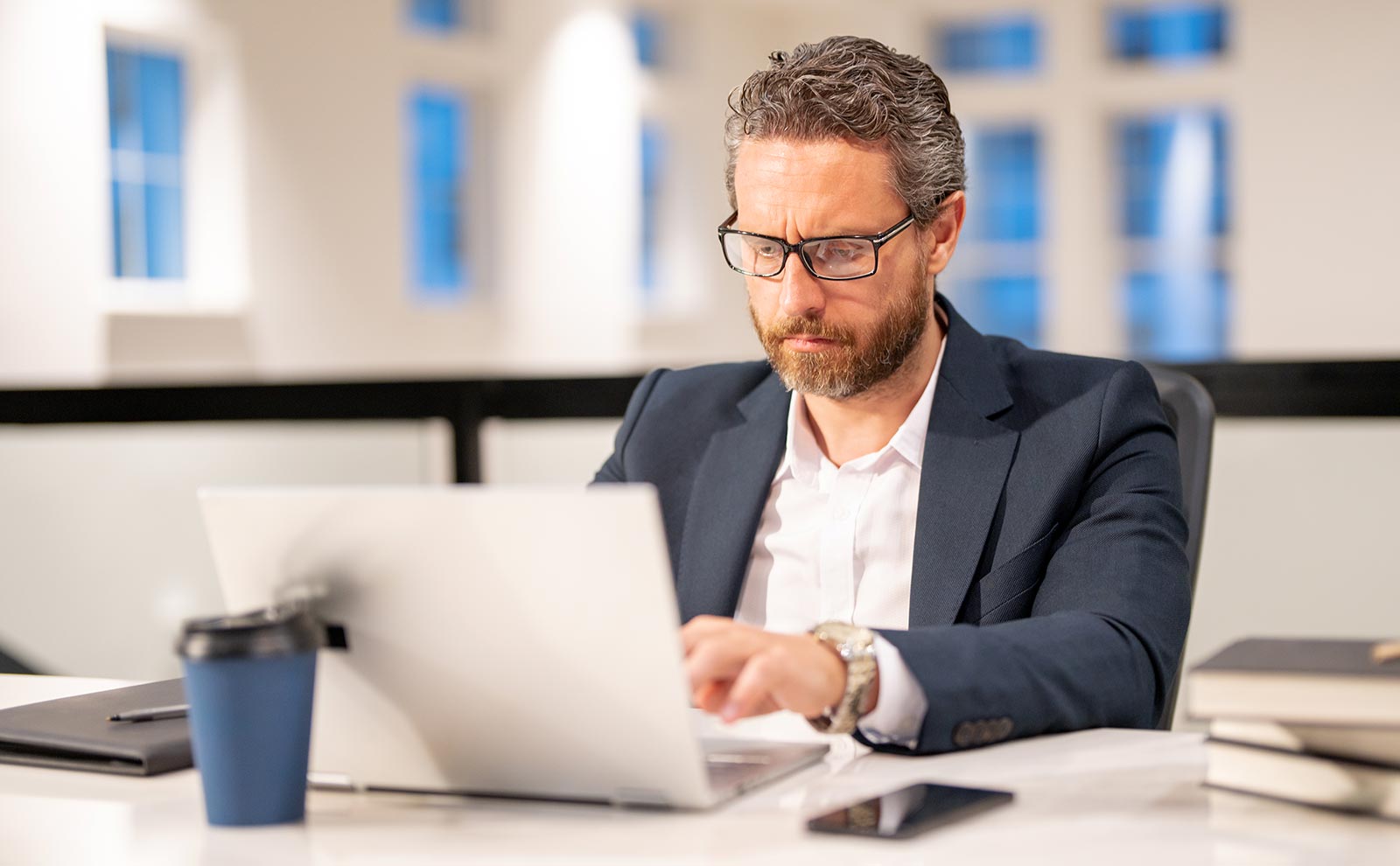focused businessman looking at his laptop