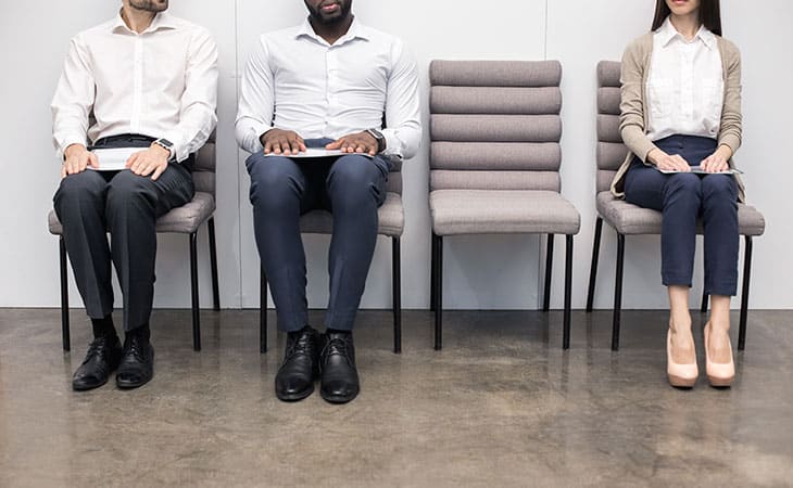 Background Check Questions: A Guide For Effective Hiring Evinex Corporation | Staffing Agency three people sitting in chairs