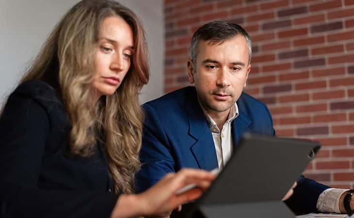 What Is A Chief Of Staff? Key Responsibilities And More Evinex Corporation | Staffing Agency a couple of business people focused on using a tablet