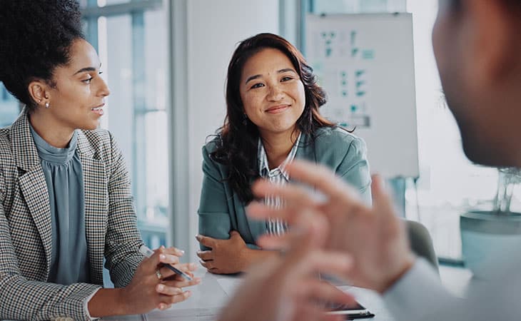 100+ Sales Manager Interview Questions With Answers Evinex Corporation | Staffing Agency a man and a woman talking to a happy woman in an office