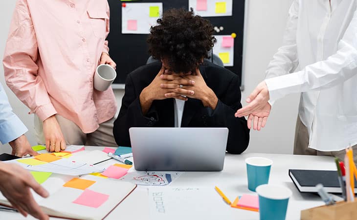 What Is A Chief Of Staff? Key Responsibilities And More Evinex Corporation | Staffing Agency a man with his hands in his face and people around him in an office