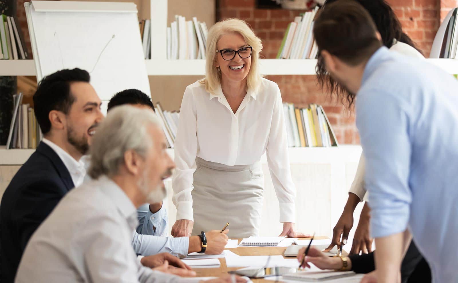 a smiling woman in a meeting in the office
