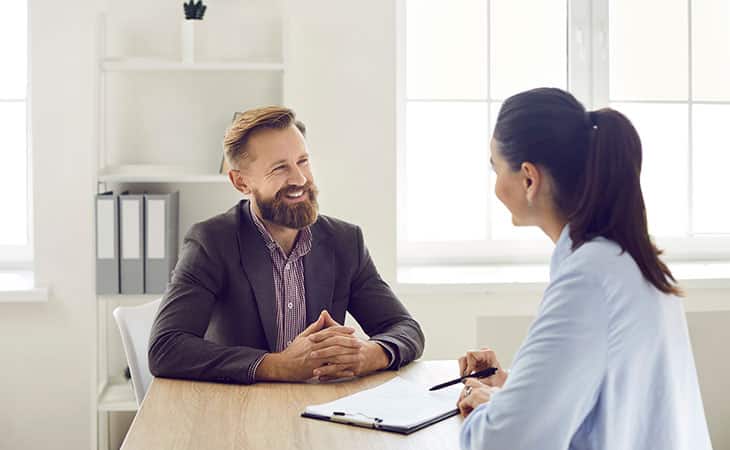 100+ Sales Manager Interview Questions With Answers Evinex Corporation | Staffing Agency a woman and a man talking in an office