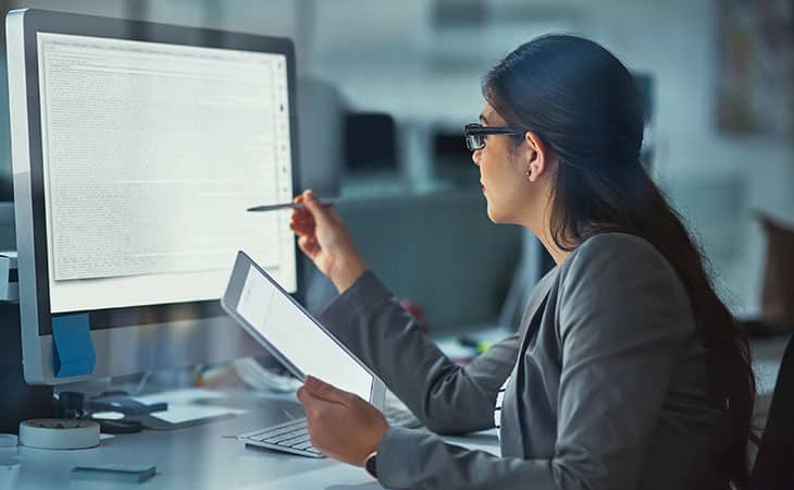 What Is Database Migration? A Step-By-Step Guide Evinex Corporation | Staffing Agency a woman checking code on the computer
