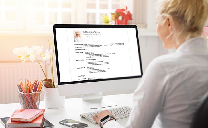 Best Fonts For Your Resume: Stand Out Professionaly Evinex Corporation | Staffing Agency a woman looking at a resume on a computer screen
