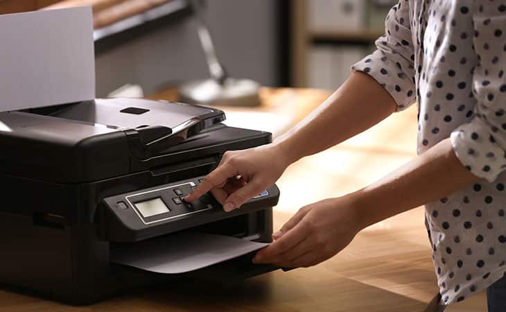 Best Fonts For Your Resume: Stand Out Professionaly Evinex Corporation | Staffing Agency detail of a woman using the printer