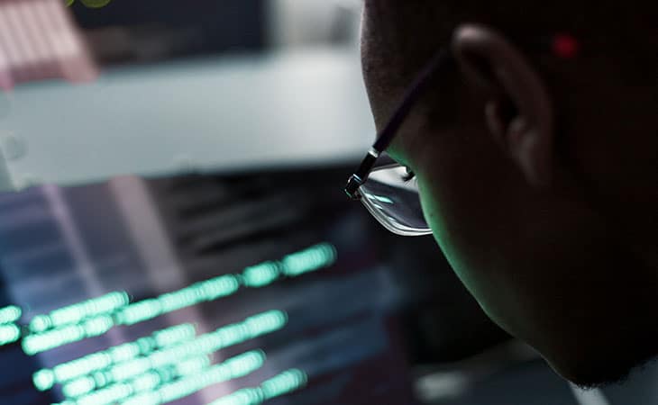 What Is Database Migration? A Step-By-Step Guide Evinex Corporation | Staffing Agency detail of an it worker looking at code