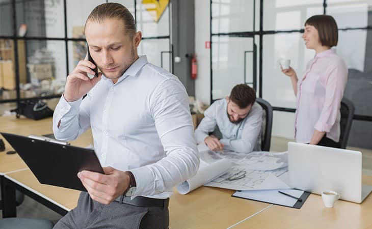 What Is A Chief Of Staff? Key Responsibilities And More Evinex Corporation | Staffing Agency people working in an office and a man using the phone
