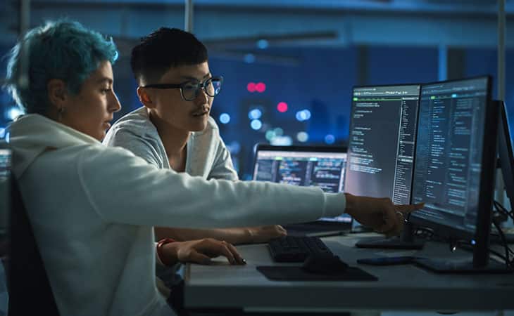 What Is A Chief Of Staff? Key Responsibilities And More Evinex Corporation | Staffing Agency two people working in an office pointing at screen