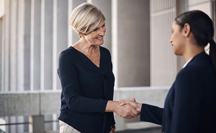 100+ Sales Manager Interview Questions With Answers Evinex Corporation | Staffing Agency two women shaking hands