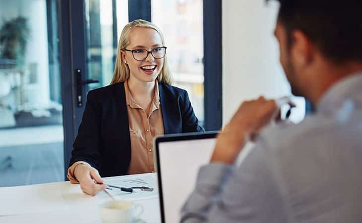 How To Conduct A Job Interview For Better Hiring Decisions Evinex Corporation | Staffing Agency a businesswoman holding a paper and smiling