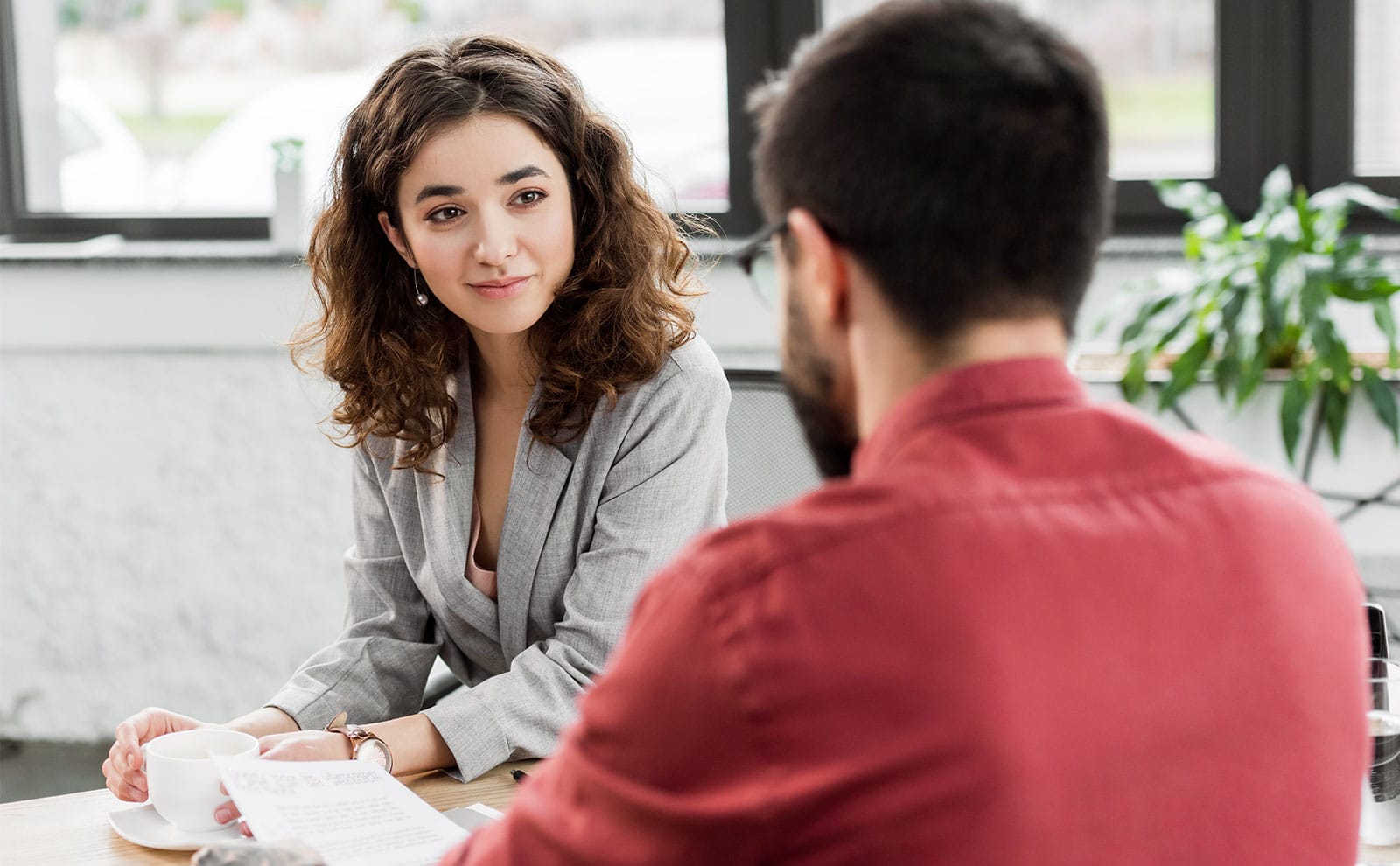 a man and a woman sitting at a table having a conversation