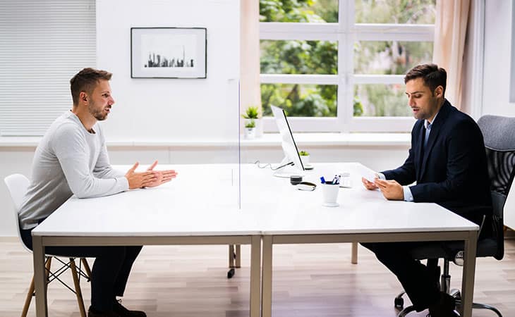 100+ Chief Of Staff Interview Questions. Find Top Leaders Evinex Corporation | Staffing Agency a man being interviewed by a businessman in a suit
