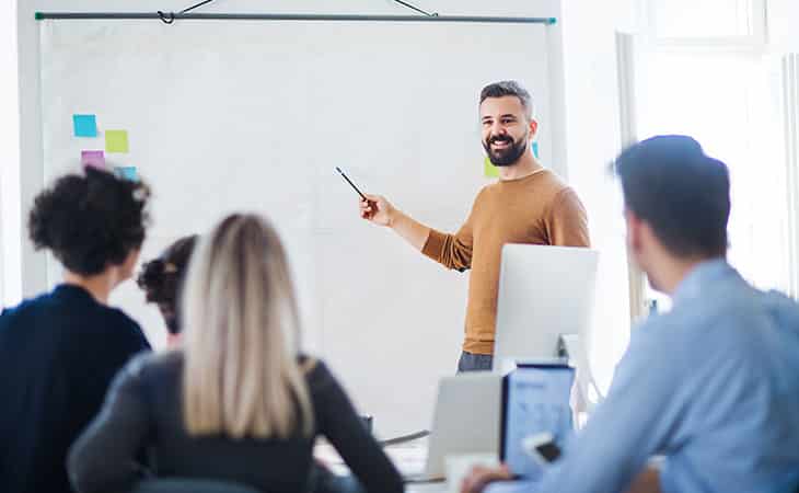 100+ Chief Of Staff Interview Questions. Find Top Leaders Evinex Corporation | Staffing Agency a man giving a speech to a group of people
