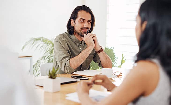 100+ Chief Of Staff Interview Questions. Find Top Leaders Evinex Corporation | Staffing Agency a thoughtful man looking at a woman during an interview