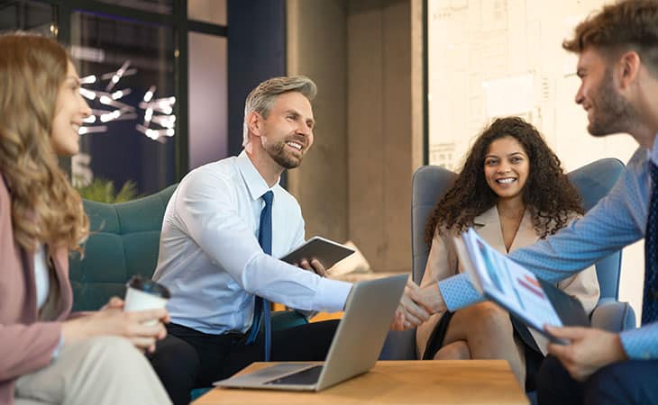 business meeting with handshake and smiles