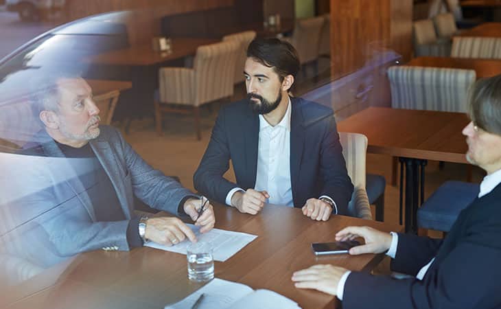 Hr Issues And Challenges: Solutions For The Modern Workplace Evinex Corporation | Staffing Agency three men discussing business topics at a table