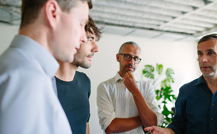 What Is Teamwork And Why Is It Important For Success? Evinex Corporation | Staffing Agency a group of people talking looking looking at each other