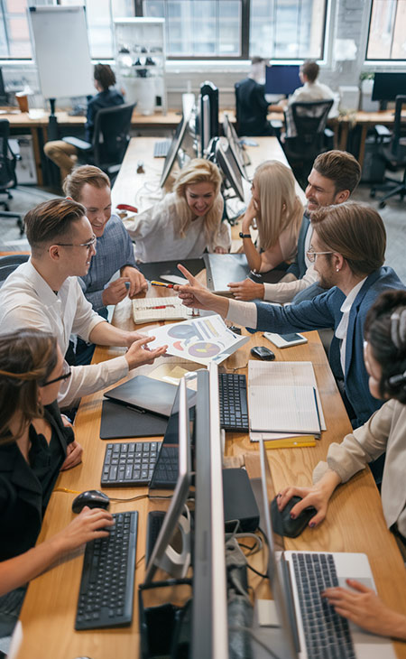 What Is Teamwork And Why Is It Important For Success? Evinex Corporation | Staffing Agency a group of people working and talking in an office together