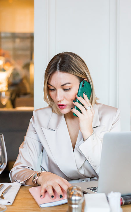 a woman on her desk talking on the phone