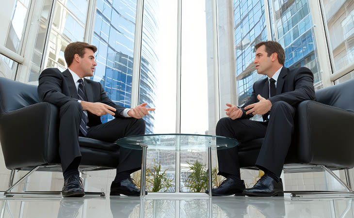 Interview Cheat Sheet: Essential Tips To Ace Your Interview Evinex Corporation | Staffing Agency businessmen talking and buildings outside