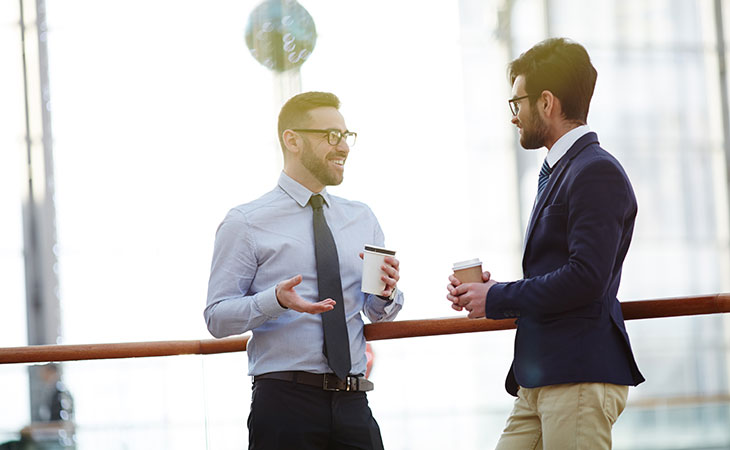 two men are having a coffee break discussion