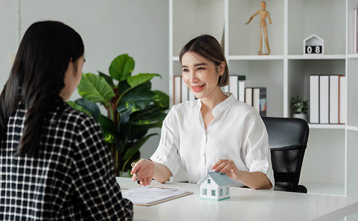 Interview Cheat Sheet: Essential Tips To Ace Your Interview Evinex Corporation | Staffing Agency two women looking to each other and pointing at papers